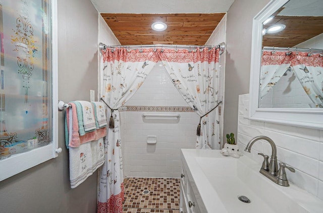 bathroom featuring vanity, a shower with shower curtain, and wooden ceiling