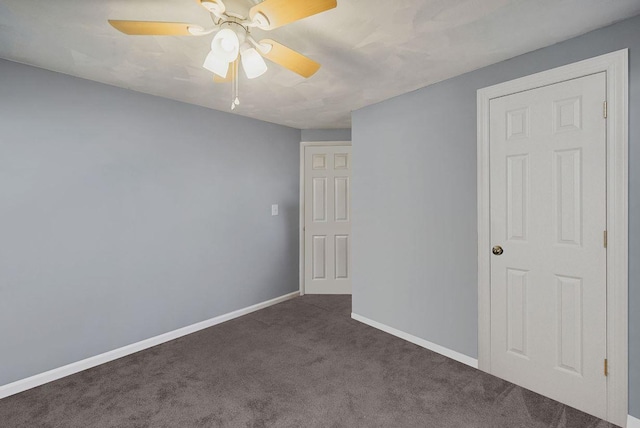 unfurnished room featuring dark carpet and ceiling fan