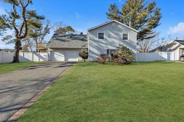 view of front of house with a garage and a front lawn