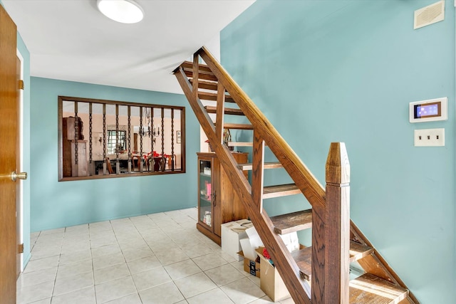 staircase with tile patterned floors