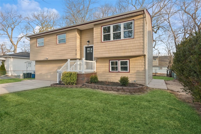 raised ranch featuring a front yard and driveway