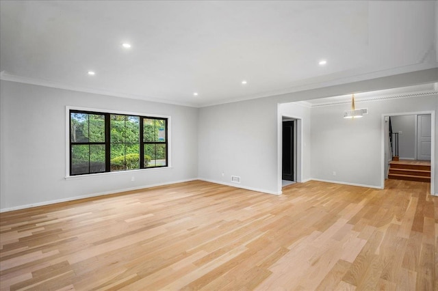 unfurnished room featuring ornamental molding and light wood-type flooring