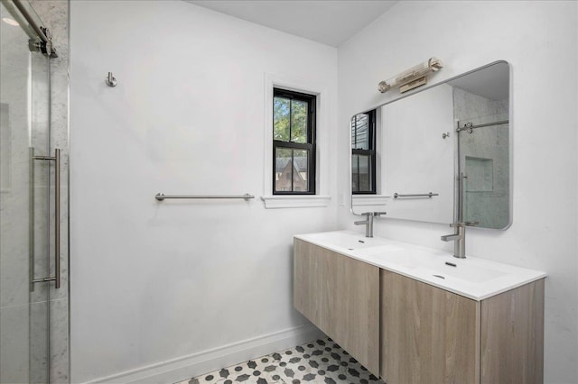 bathroom featuring a shower with door and vanity