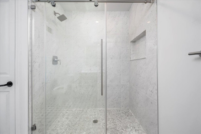 bathroom featuring a shower with shower door