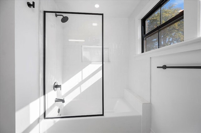 bathroom featuring combined bath / shower with glass door