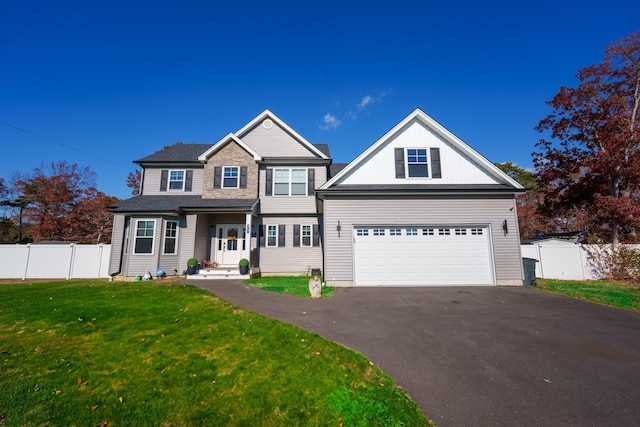 view of front of house with a garage and a front lawn