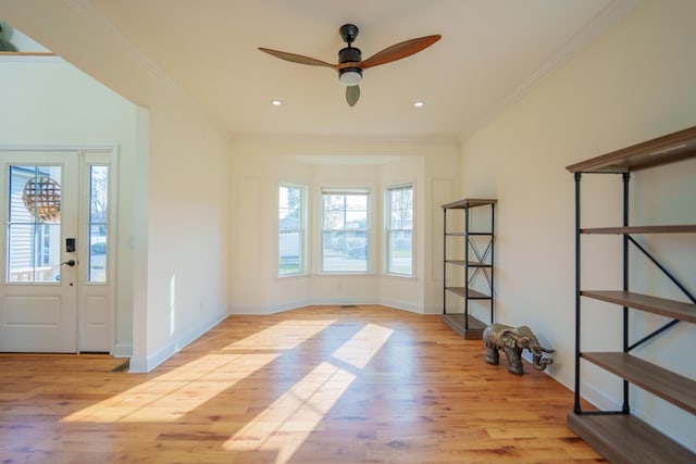 foyer featuring crown molding, ceiling fan, and light hardwood / wood-style flooring