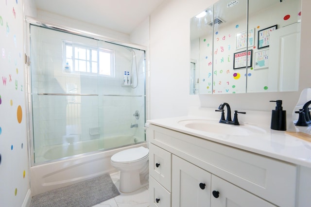 full bathroom with enclosed tub / shower combo, vanity, and toilet