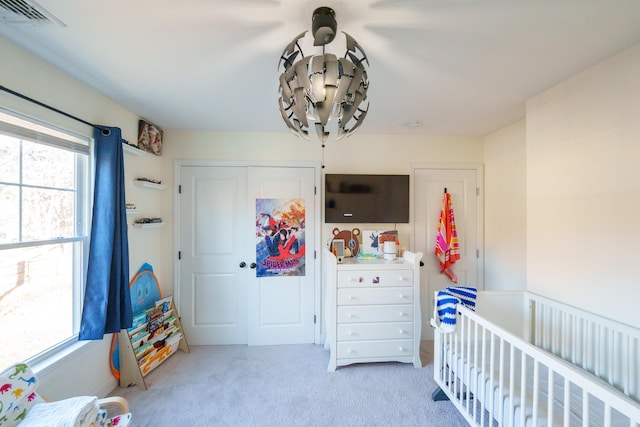 bedroom featuring light colored carpet and a closet