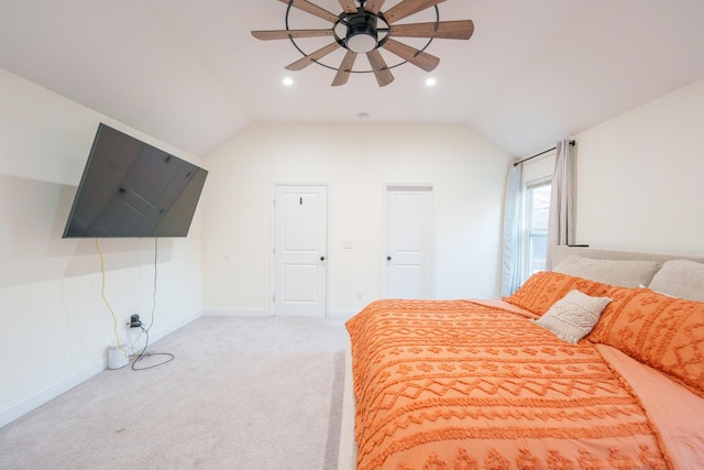 bedroom featuring vaulted ceiling, light colored carpet, and ceiling fan