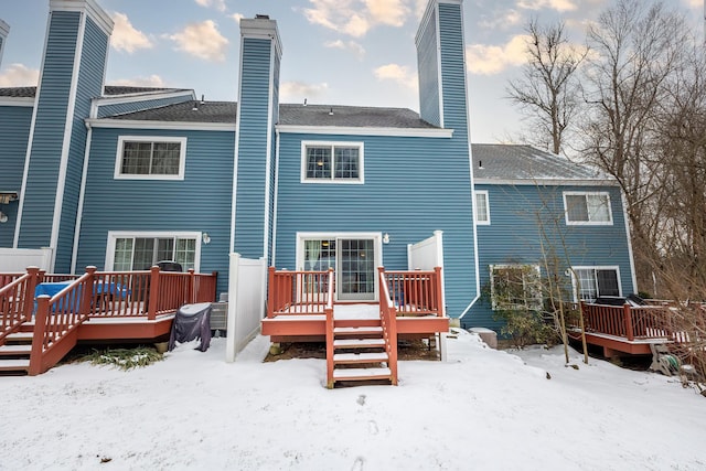 snow covered property featuring a wooden deck