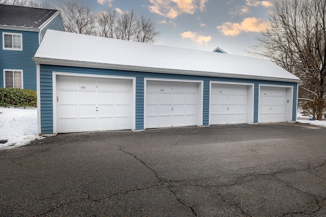 view of garage at dusk