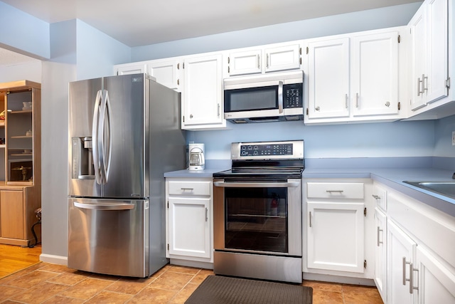 kitchen with white cabinetry and appliances with stainless steel finishes