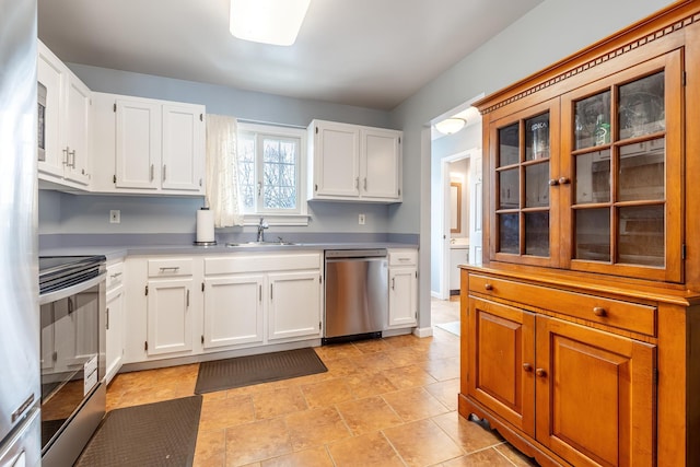 kitchen with white cabinetry, sink, and stainless steel appliances