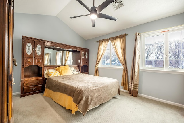 bedroom featuring lofted ceiling, light colored carpet, and ceiling fan