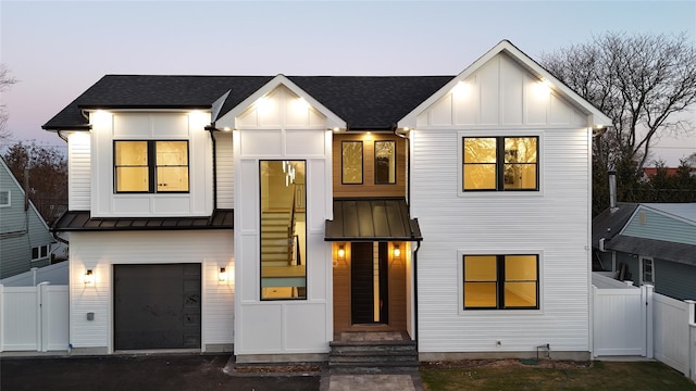 modern inspired farmhouse featuring a garage