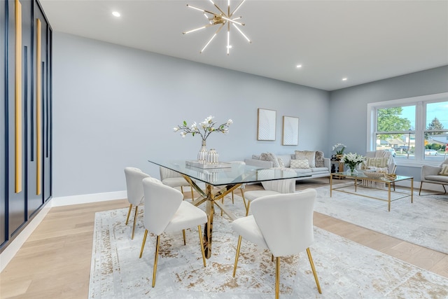 dining area featuring an inviting chandelier and light hardwood / wood-style floors