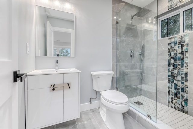 bathroom featuring vanity, tiled shower, and toilet