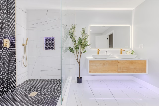 bathroom with tiled shower and vanity