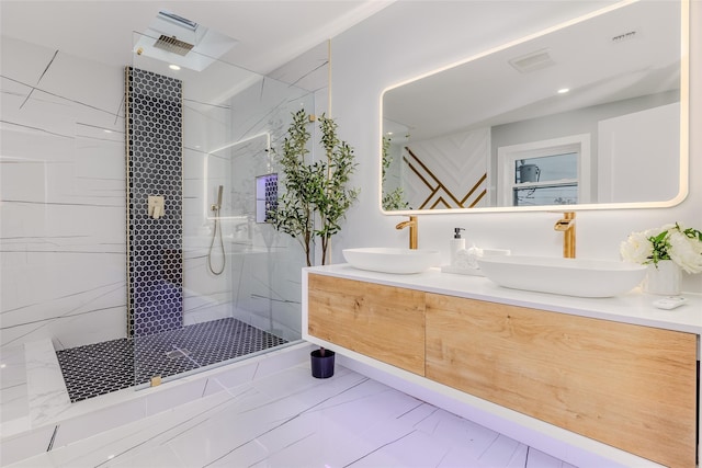 bathroom with vanity and tiled shower