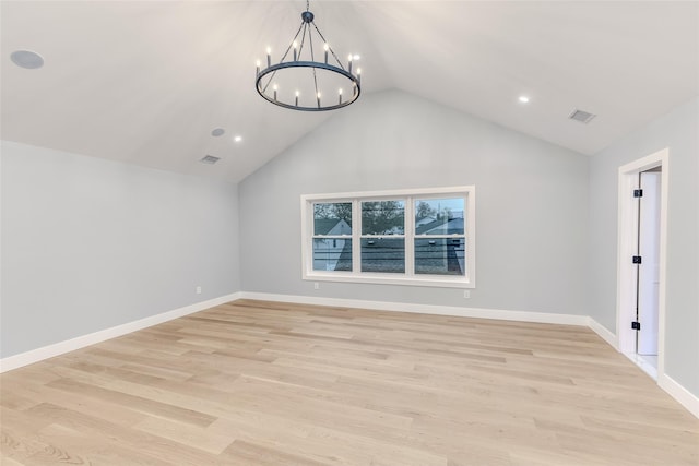 interior space with lofted ceiling, a notable chandelier, and light wood-type flooring