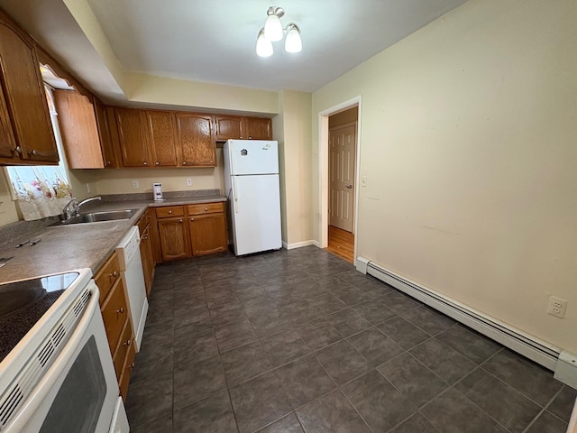 kitchen with a baseboard heating unit, white appliances, a sink, brown cabinets, and dark countertops