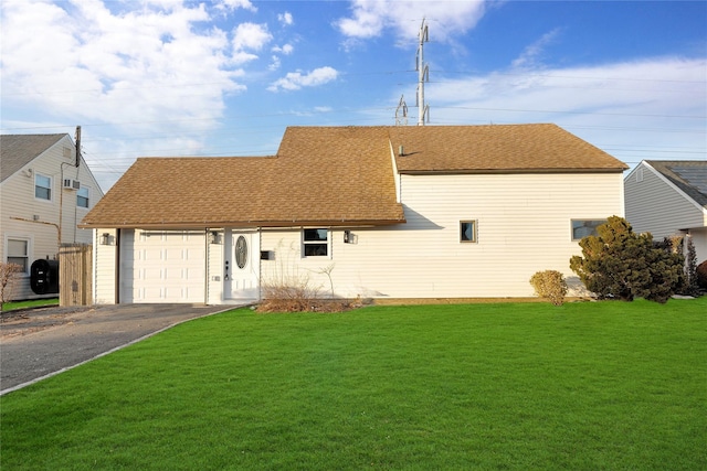 view of front of house featuring a garage and a front lawn