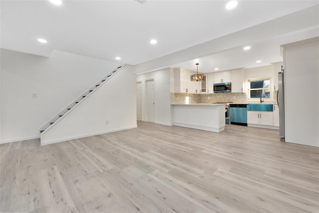 unfurnished living room with sink and light hardwood / wood-style flooring