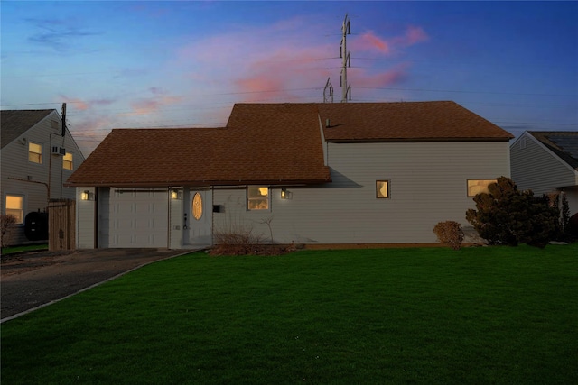 view of front of home featuring a yard and a garage