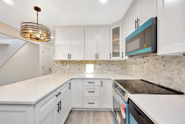 kitchen with white cabinetry and stainless steel range with electric cooktop