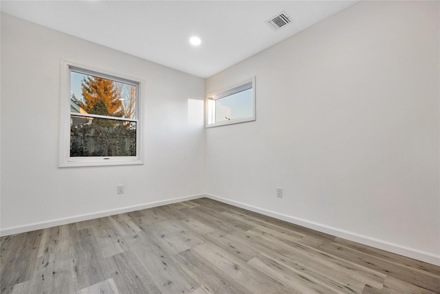 spare room with light hardwood / wood-style floors