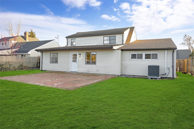 back of house with a patio area, central air condition unit, and a lawn