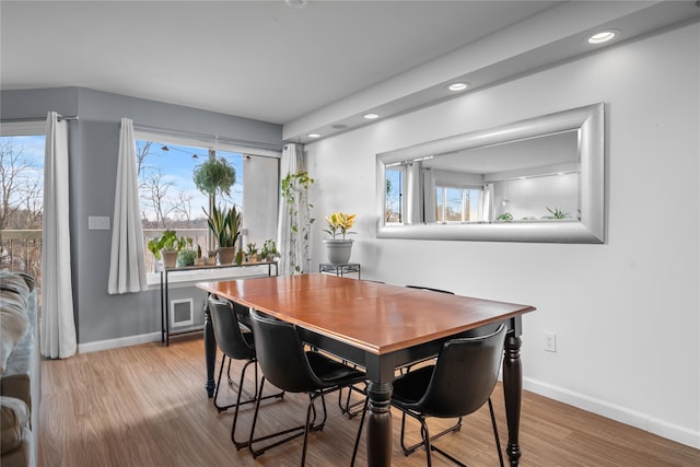 dining space with light wood-type flooring and a wealth of natural light