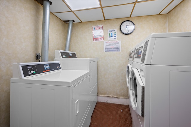 clothes washing area with washer and clothes dryer