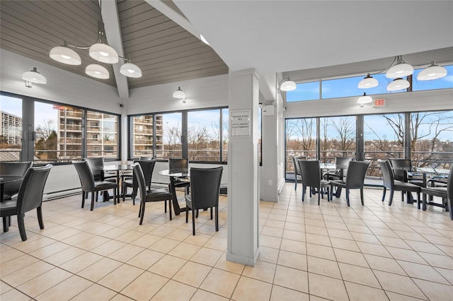 dining space featuring light tile patterned floors and high vaulted ceiling