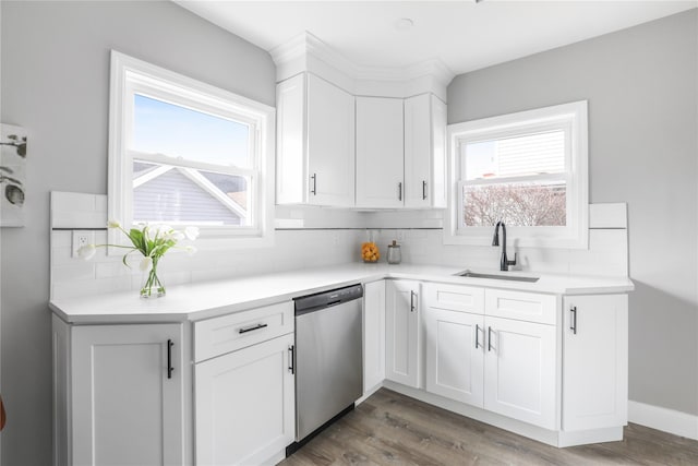 kitchen with sink, dishwasher, backsplash, white cabinets, and dark hardwood / wood-style flooring