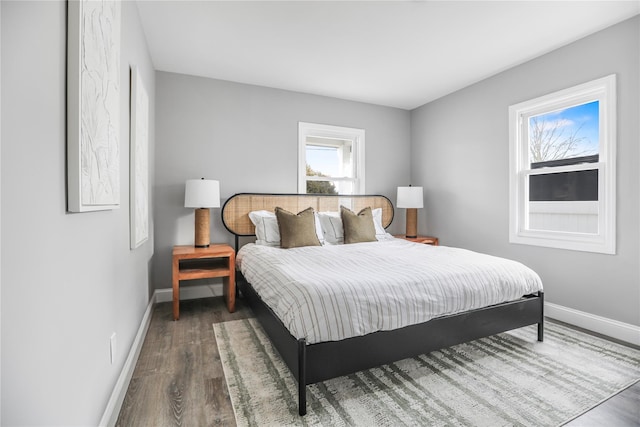 bedroom with dark hardwood / wood-style flooring