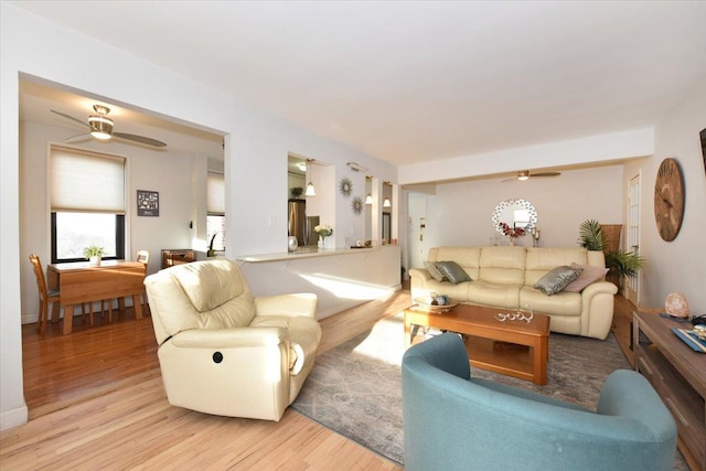 living room featuring ceiling fan and light hardwood / wood-style floors