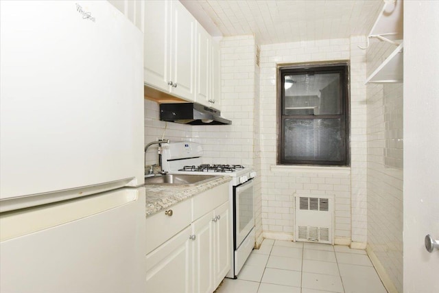 kitchen with white cabinetry, sink, decorative backsplash, light tile patterned floors, and white appliances