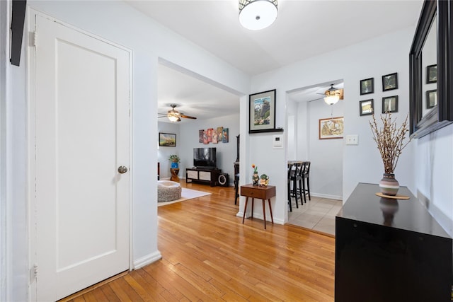 corridor with light hardwood / wood-style floors