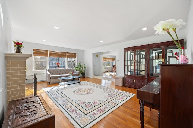 living room featuring radiator heating unit and light hardwood / wood-style flooring