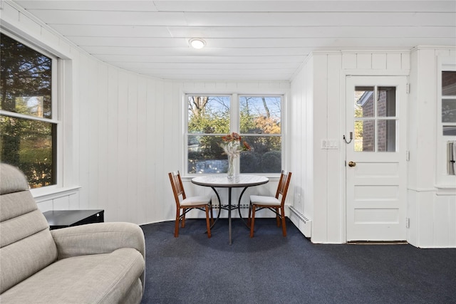 dining area featuring dark colored carpet and a baseboard radiator