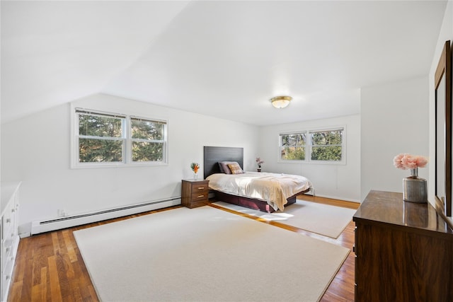 bedroom featuring lofted ceiling, dark hardwood / wood-style floors, and baseboard heating