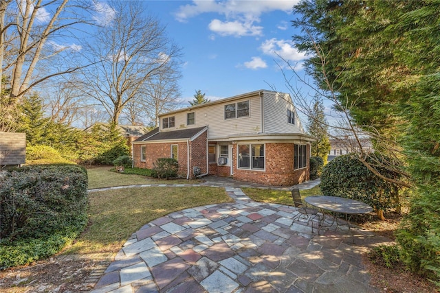 front of property featuring a patio and a front lawn