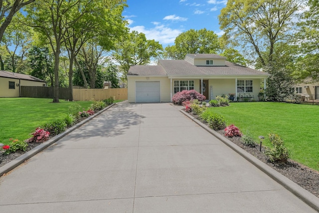 view of front of home with a garage and a front lawn