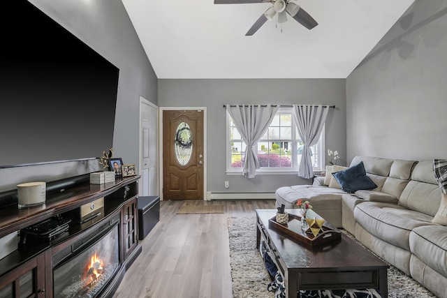 living room with ceiling fan, high vaulted ceiling, a baseboard heating unit, and light hardwood / wood-style floors