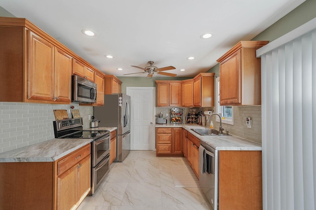 kitchen featuring sink, backsplash, stainless steel appliances, and ceiling fan