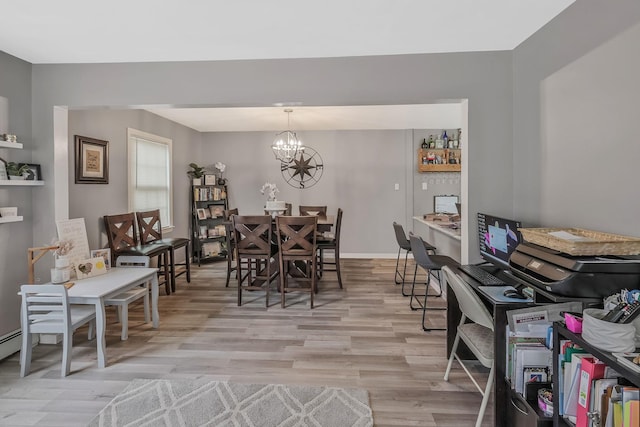 dining area with an inviting chandelier and light wood-type flooring