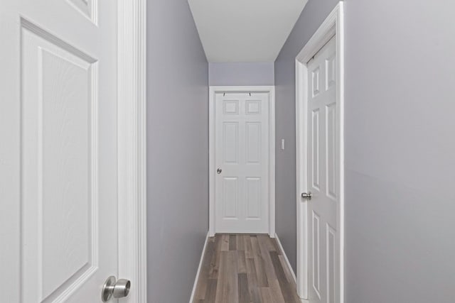 corridor with wood-type flooring