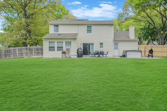 back of house with a yard and a patio area